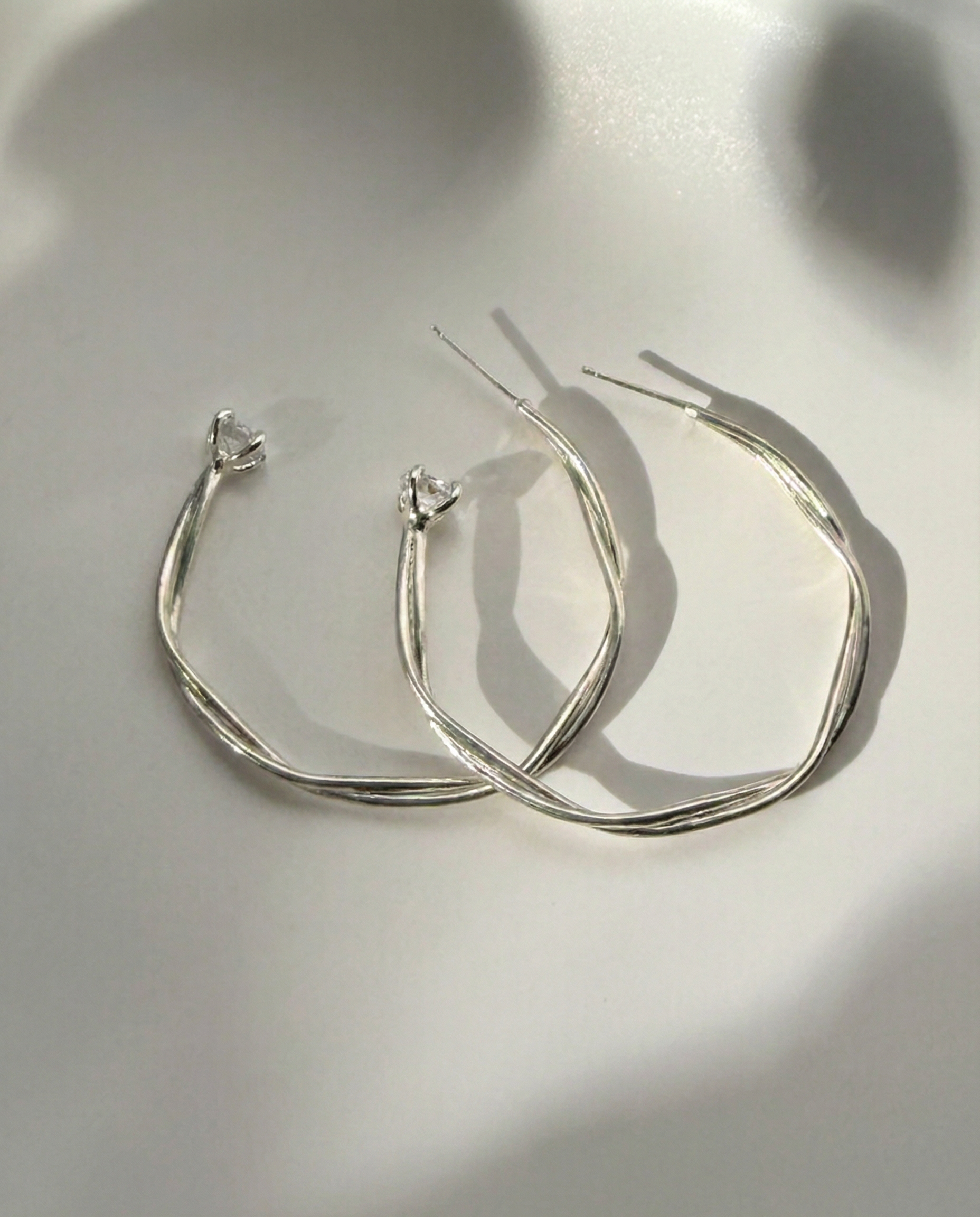 Astraea Twist Hoop Earrings in sterling silver with handcrafted twist and natural Herkimer diamond accents