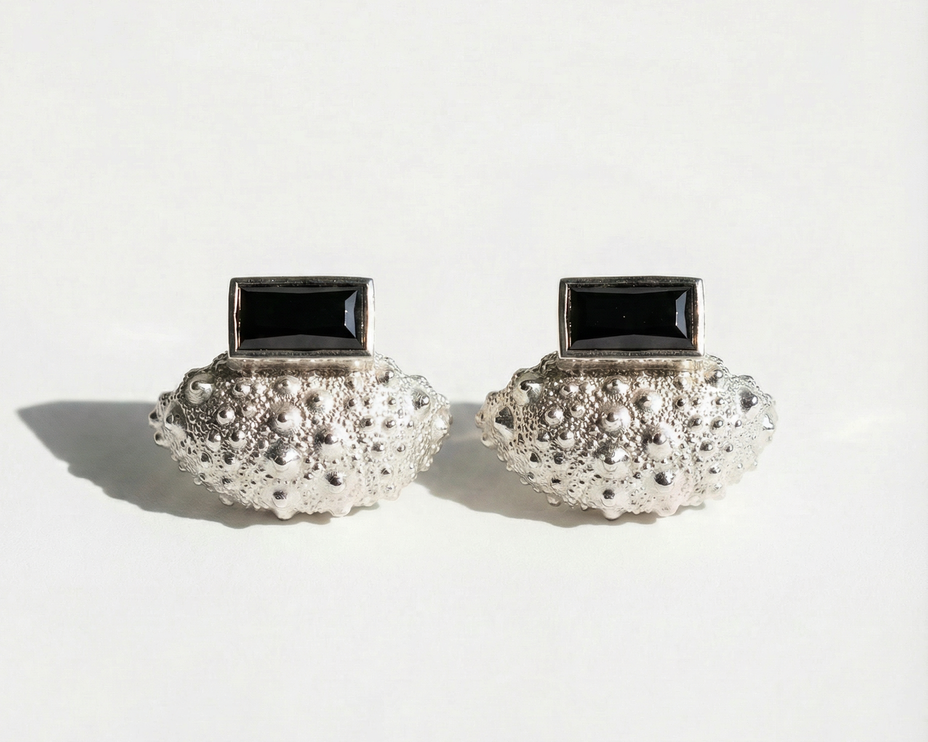 Ceto urchin ear jacket and spinel post shown separately on white background, sterling silver