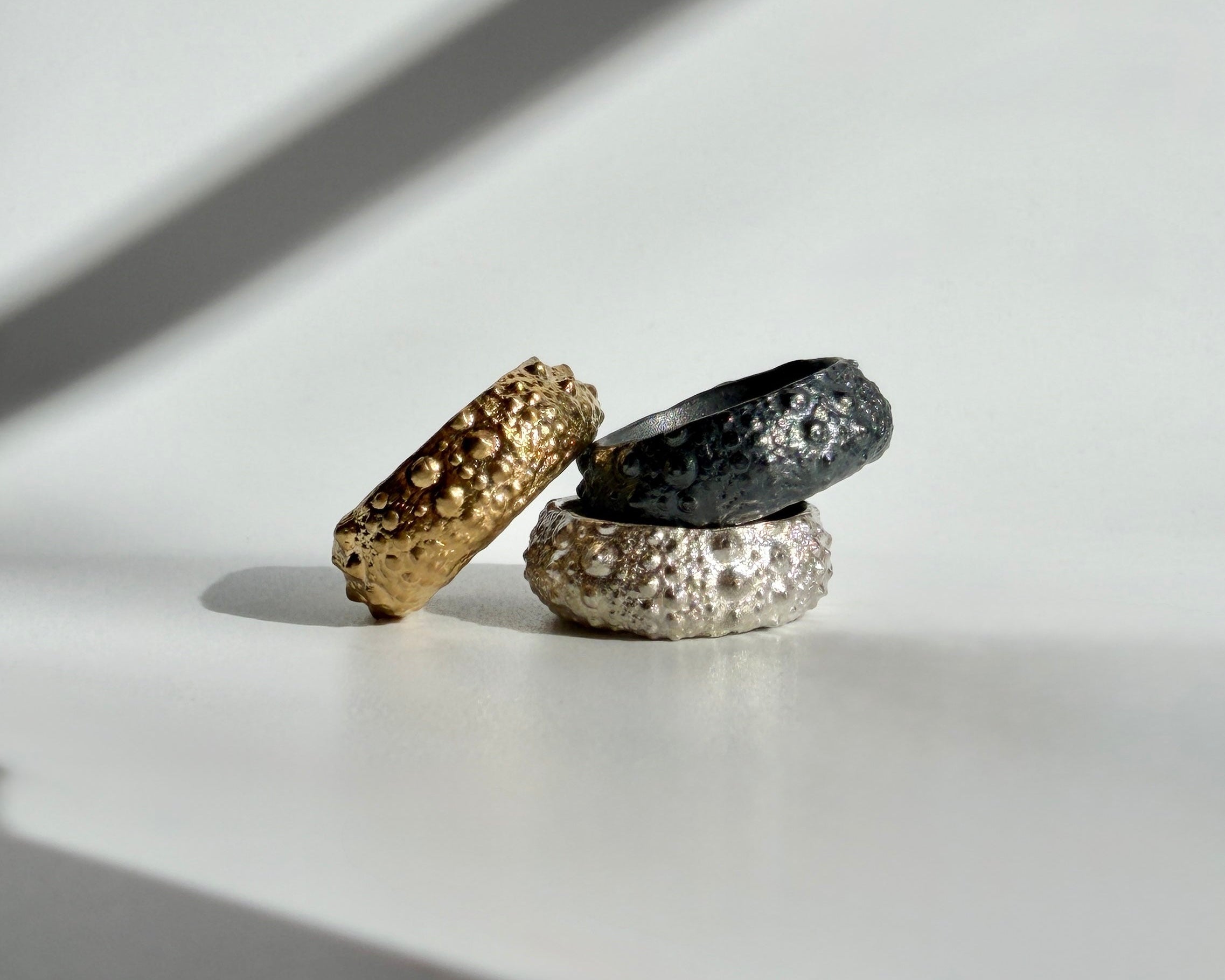 Galene Urchin Ring in gold vermeil, sterling silver, and oxidized silver with preserved sea urchin shell texture by Kefi