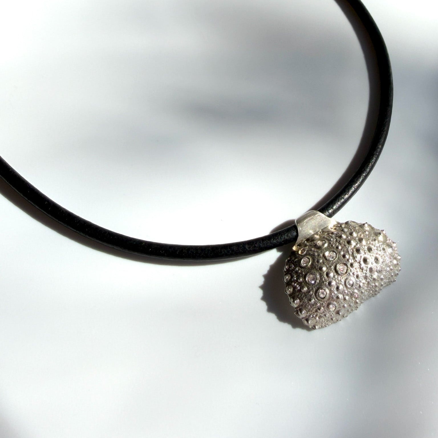 Sterling silver urchin necklace on leather cord with diamonds